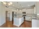 Modern kitchen featuring white cabinetry, granite countertops, and a kitchen island at 4650 Pleasant Woods Dr, Cumming, GA 30028