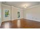 Sunlit living room showcasing hardwood floors, neutral paint, and stylish trim details at 4650 Pleasant Woods Dr, Cumming, GA 30028