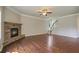 Spacious living room featuring hardwood floors and a stone fireplace, perfect for cozy gatherings at 4650 Pleasant Woods Dr, Cumming, GA 30028