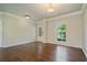 Sunlit living room showcasing hardwood floors, neutral paint, and stylish trim details at 4650 Pleasant Woods Dr, Cumming, GA 30028