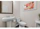 Stylish half bathroom with a pedestal sink and a modern mirror at 118 Woodhouse Cir, Acworth, GA 30102