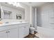 Bright bathroom features a double vanity, large mirror, toilet, and shower tub combination at 118 Woodhouse Cir, Acworth, GA 30102