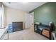 Bedroom with neutral walls and carpet, contrasting green accent wall, and a storage console table at 118 Woodhouse Cir, Acworth, GA 30102