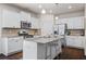 Bright kitchen features white cabinets, stainless steel appliances, and granite countertops at 118 Woodhouse Cir, Acworth, GA 30102