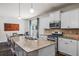 Kitchen island with granite countertops, pendant lighting, and stainless steel appliances at 118 Woodhouse Cir, Acworth, GA 30102