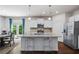 Kitchen with white cabinets, stainless steel appliances, and adjacent dining area and backyard access at 118 Woodhouse Cir, Acworth, GA 30102