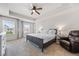 Spacious main bedroom with a tray ceiling, large windows, and an ensuite bathroom at 118 Woodhouse Cir, Acworth, GA 30102
