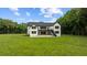 Beautiful back exterior view of the modern farmhouse showcasing the spacious backyard and deck at 1604 Greendale Rd, Covington, GA 30014