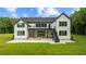 Back exterior featuring a raised stone patio and a deck with stairs to access the yard at 1604 Greendale Rd, Covington, GA 30014