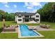 Stunning backyard oasis with a sparkling pool, outdoor dining, fireplace, and lounge area, ideal for entertaining at 1604 Greendale Rd, Covington, GA 30014