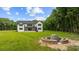 Large level yard with a stylish stone fire pit and stone seating, ideal for outdoor gatherings at 1604 Greendale Rd, Covington, GA 30014