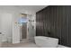 Sleek bathroom with glass shower and soaking tub against a modern accent wall at 1604 Greendale Rd, Covington, GA 30014