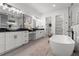 Bright bathroom featuring double vanities, a soaking tub, and marble accents at 1604 Greendale Rd, Covington, GA 30014
