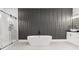 Luxury bathroom featuring a soaking tub, glass enclosed shower and modern fixtures at 1604 Greendale Rd, Covington, GA 30014