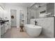 Elegant bathroom with a soaking tub, dual vanities, and a walk-in shower at 1604 Greendale Rd, Covington, GA 30014