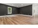 Stylish bedroom featuring wood floors, designer accent wall, and natural light at 1604 Greendale Rd, Covington, GA 30014