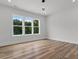 Well-lit bedroom with hardwood floors and scenic outdoor views from the windows at 1604 Greendale Rd, Covington, GA 30014