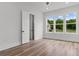 Sunlit bedroom featuring hardwood floors and large windows with a view at 1604 Greendale Rd, Covington, GA 30014