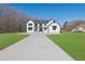 Beautiful two-story modern farmhouse with a long driveway, black trim, and pristine green lawn at 1604 Greendale Rd, Covington, GA 30014