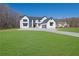 Stunning two-story modern farmhouse with black trim, white siding, and an expansive green lawn at 1604 Greendale Rd, Covington, GA 30014