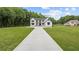 Stunning home with a long driveway, lush lawn, and modern design, offering curb appeal and privacy at 1604 Greendale Rd, Covington, GA 30014