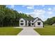 Beautiful new construction modern farmhouse with an extra long driveway and front lawn at 1604 Greendale Rd, Covington, GA 30014