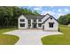 Stunning two-story modern farmhouse with black trim and a large concrete driveway at 1604 Greendale Rd, Covington, GA 30014
