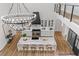 Bright kitchen features a large island with seating, stainless steel appliances, and a modern chandelier at 1604 Greendale Rd, Covington, GA 30014