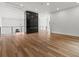 Spacious living area with hardwood floors, a black marble fireplace and chandelier lighting at 1604 Greendale Rd, Covington, GA 30014