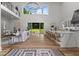 An open concept living space with a modern kitchen and large windows overlooking the backyard at 1604 Greendale Rd, Covington, GA 30014