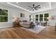 Bright main bedroom featuring wood floors, a tray ceiling, and views of the outdoors at 1604 Greendale Rd, Covington, GA 30014