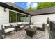 Cozy outdoor patio with seating, a fire pit, and a view of the trees at 1604 Greendale Rd, Covington, GA 30014