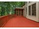 Spacious back deck leading to a screened in porch surrounded by lush greenery at 1917 Oak Grove Ne Rd, Atlanta, GA 30345
