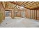 Large unfinished basement showing wood framing, insulation, concrete floors, and an exterior door to the outside at 1917 Oak Grove Ne Rd, Atlanta, GA 30345