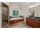 Bathroom showcasing the tub, shower, vanity, and tile flooring at 1917 Oak Grove Ne Rd, Atlanta, GA 30345