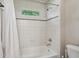 Bright white bathroom with shower/tub combo, modern fixtures, and window at 1917 Oak Grove Ne Rd, Atlanta, GA 30345