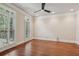Bedroom features hardwood floors, large windows with plantation shutters, and recessed lighting at 1917 Oak Grove Ne Rd, Atlanta, GA 30345