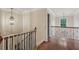 Upstairs landing featuring hardwood floors, chandelier and classic staircase with wood railing at 1917 Oak Grove Ne Rd, Atlanta, GA 30345
