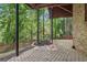 Covered patio with brick columns and paving stones, offering a shaded outdoor space with a wooded view at 1917 Oak Grove Ne Rd, Atlanta, GA 30345