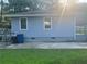 Back exterior of the home showing siding, windows and the level yard at 2530 Old Colony Rd, East Point, GA 30344