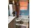 Compact bathroom featuring a tub, toilet, and vanity, with practical storage options at 2530 Old Colony Rd, East Point, GA 30344