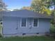 Exterior view of the home showcasing the gray siding and backyard at 2530 Old Colony Rd, East Point, GA 30344