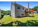 Back exterior of home with a well-maintained lawn and a wooden deck at 4426 High Gate Nw Dr, Acworth, GA 30101