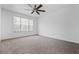 Spacious bedroom features neutral carpet, a ceiling fan, and a bright window at 4426 High Gate Nw Dr, Acworth, GA 30101