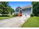 Inviting two-story home with a well-manicured lawn and a long driveway leading to a two-car garage at 4426 High Gate Nw Dr, Acworth, GA 30101