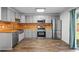 Modern kitchen featuring stainless steel appliances, gray cabinetry, and wood backsplash at 4426 High Gate Nw Dr, Acworth, GA 30101
