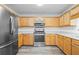 Bright kitchen with stainless steel appliances and wood cabinets at 4426 High Gate Nw Dr, Acworth, GA 30101