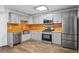 Spacious kitchen with stainless appliances, light grey cabinets, and wooden backsplash at 4426 High Gate Nw Dr, Acworth, GA 30101