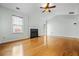 Bright living room with hardwood floors, a fireplace, and a ceiling fan for comfortable living and relaxation at 4426 High Gate Nw Dr, Acworth, GA 30101