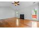 Inviting living room with hardwood floors, fireplace, ceiling fan, and lots of natural light at 4426 High Gate Nw Dr, Acworth, GA 30101